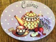 Placa de cocina con tetera, taza y fruta (con texto CUINA)